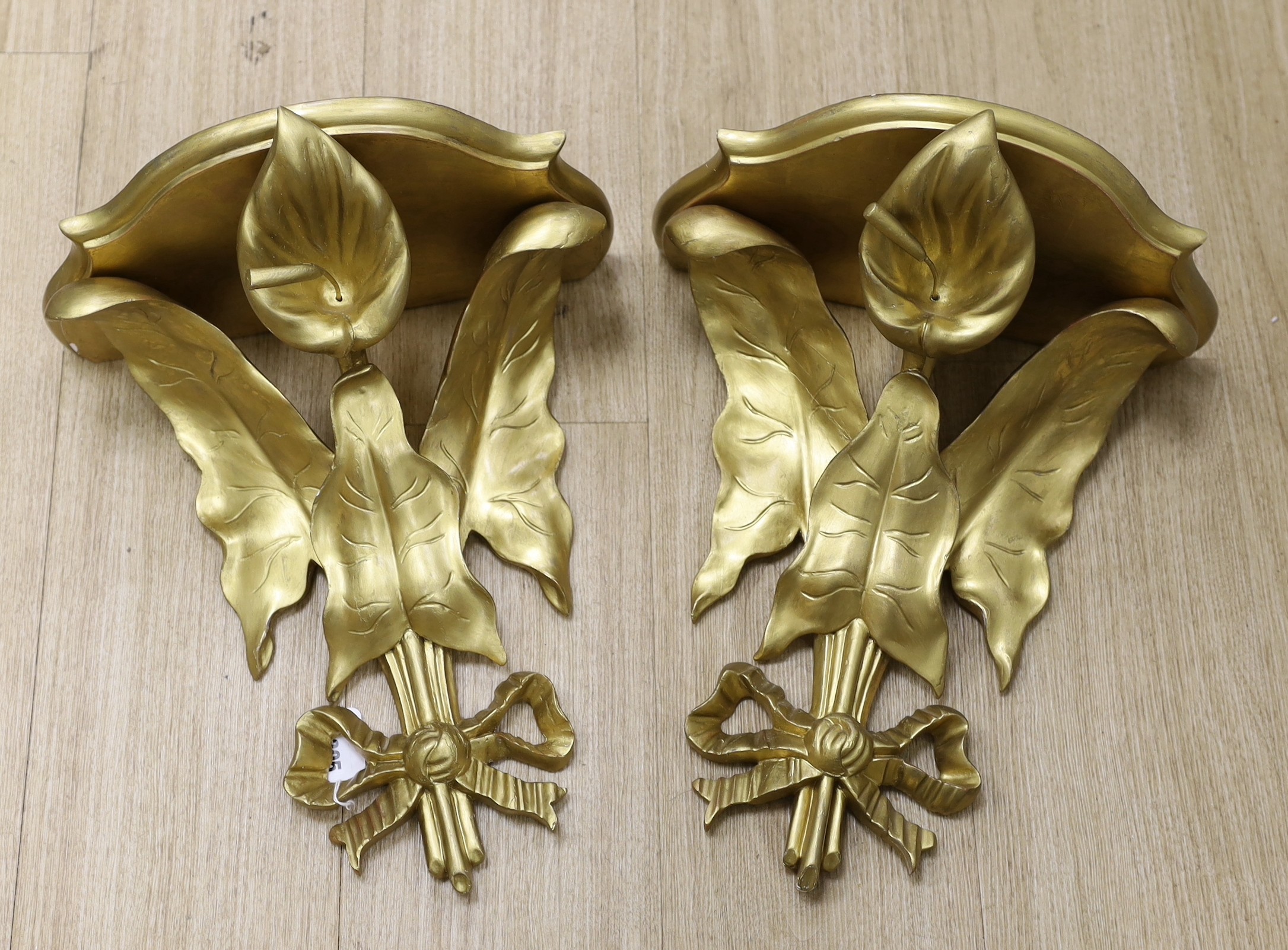 A pair of decorative ivy carved giltwood wall brackets, 40cms high